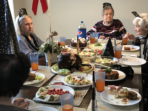 A festive family dinner featuring a variety of dishes, drinks, and desserts, bringing loved ones together for a cherished gathering.