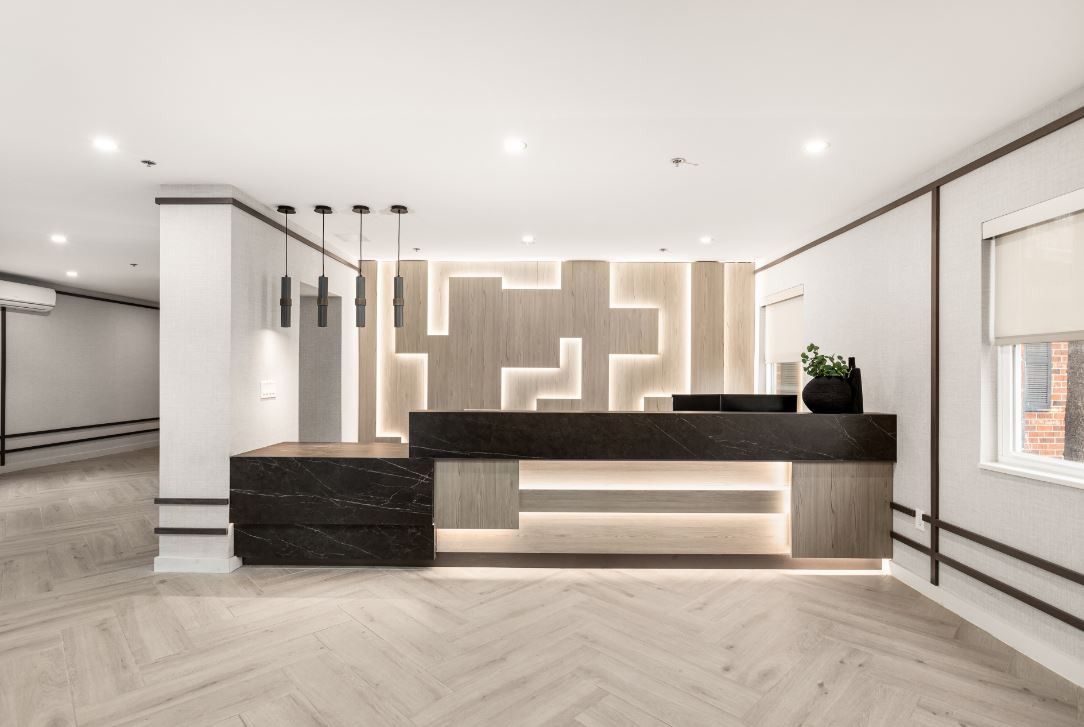 A sleek, modern reception area with minimalist design and ambient lighting.