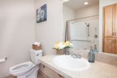 A modern and clean bathroom with a sink, toilet, and decorative elements.