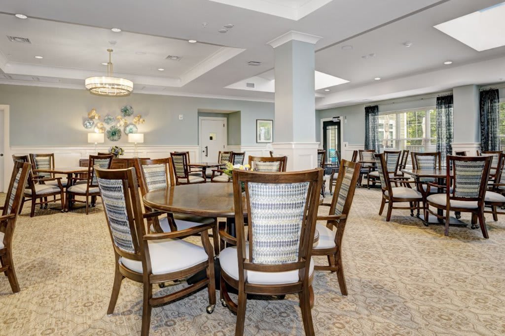 A modern, spacious dining area with elegant furniture arrangement.
