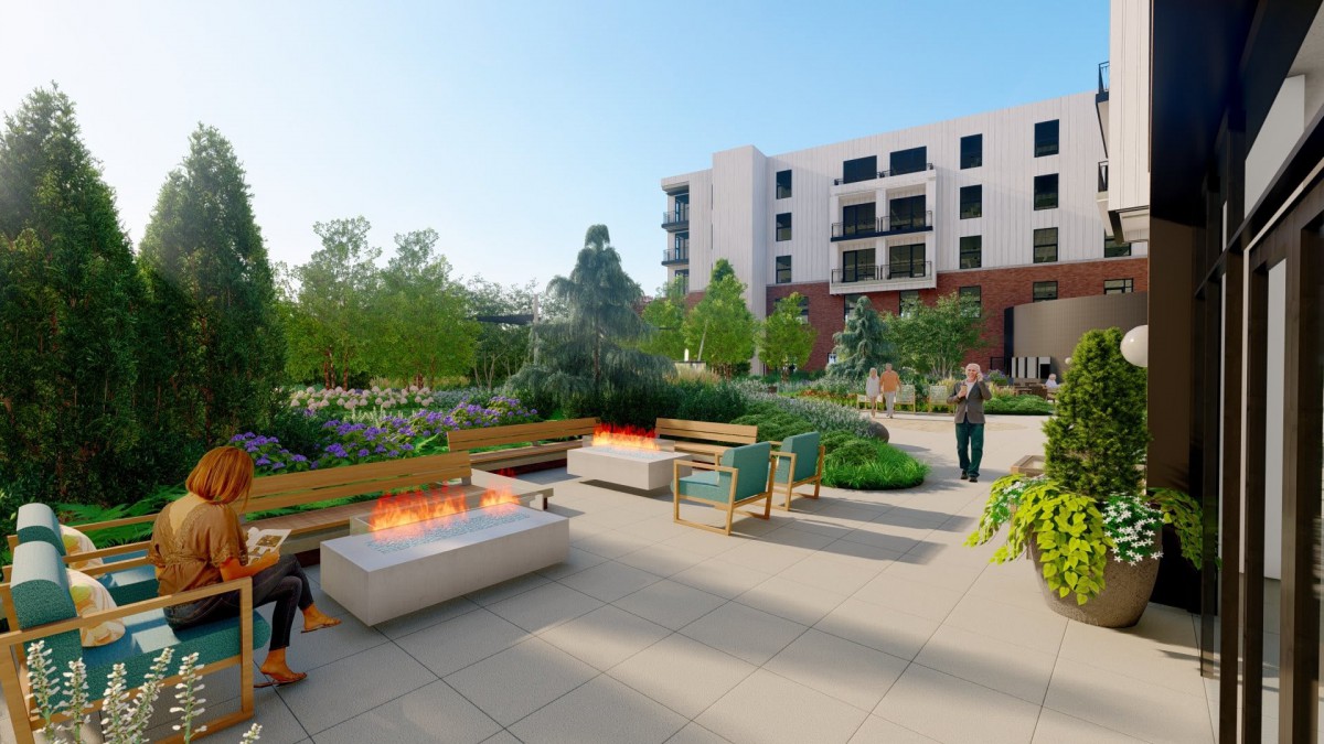 A modern rooftop garden featuring outdoor seating, fire pits, and lush greenery, adjacent to a contemporary apartment building.
