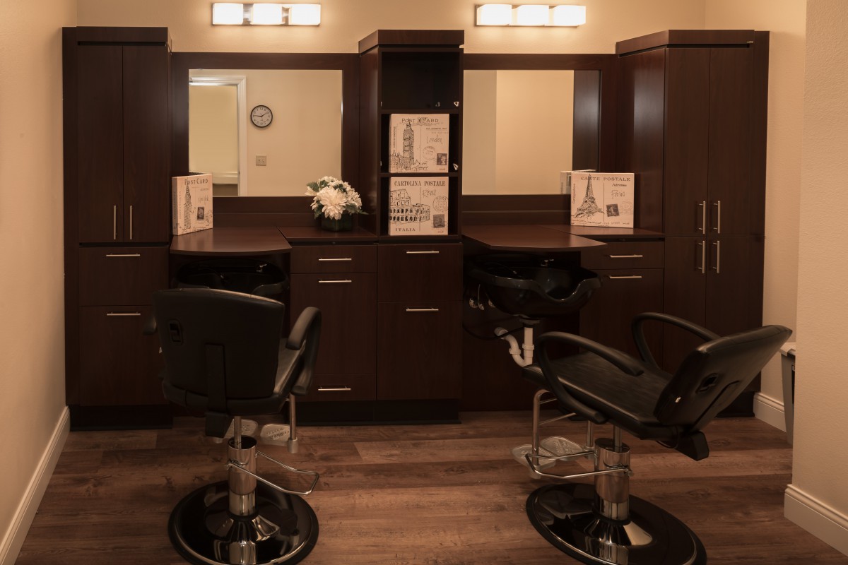 A cozy hair salon with styling chairs and mirrors.