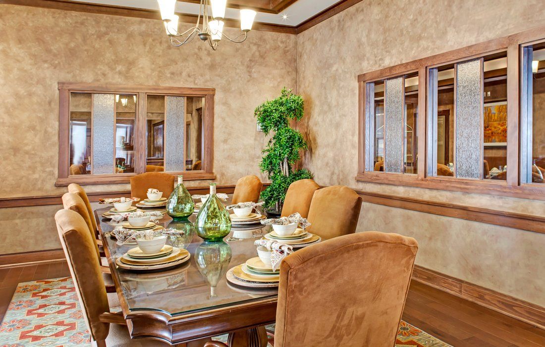 A traditional dining room with a classic table setting and elegant decor.