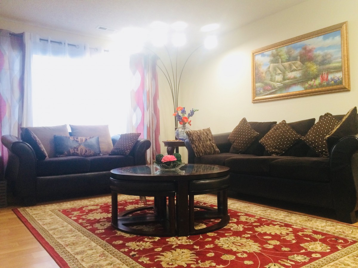 A cozy living room with comfortable sofas and a decorative rug.