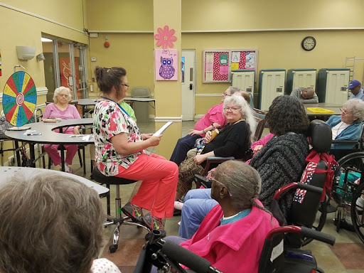 A lively gathering at the community center, where seniors engage in an interactive group session.