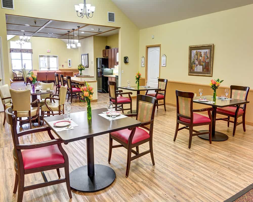 A cozy dining area with neatly arranged tables and chairs in a well-lit restaurant.