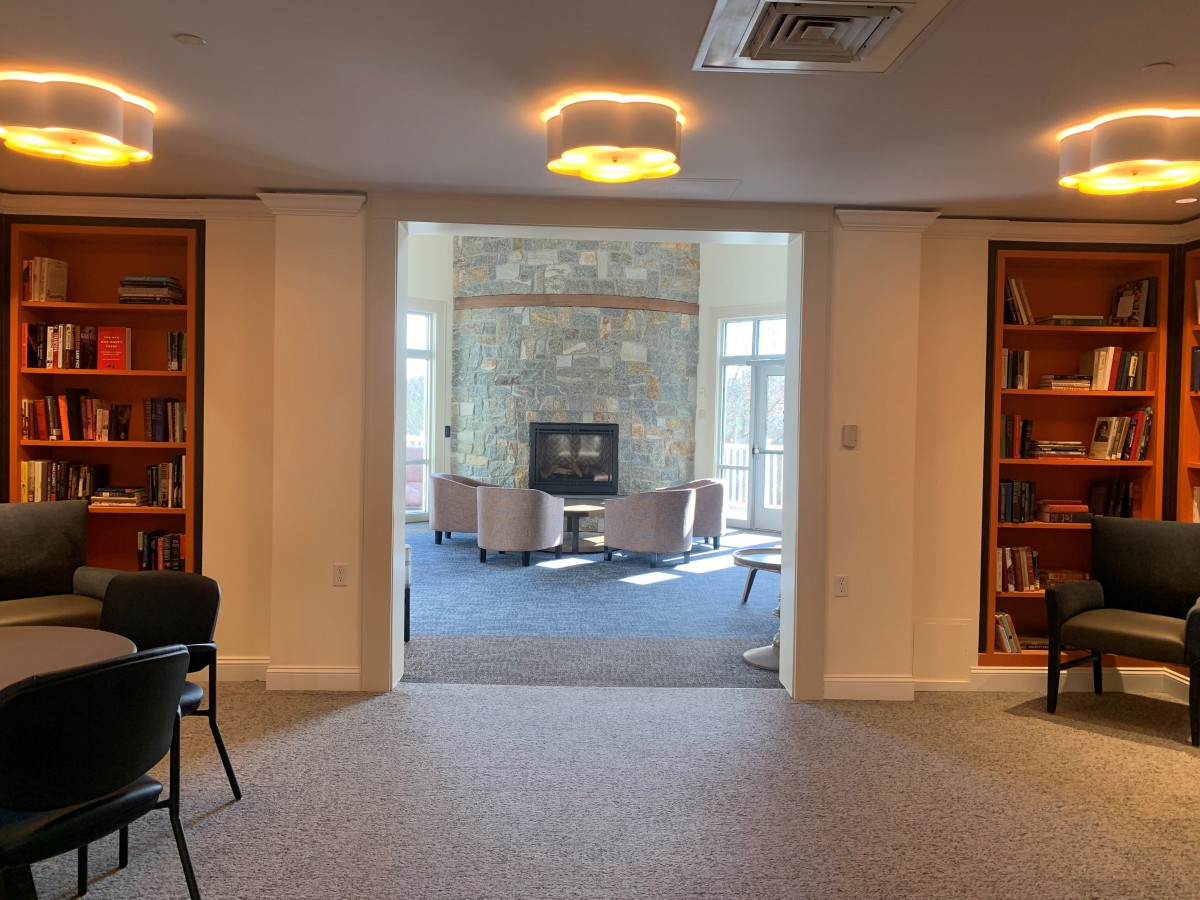 A cozy library interior with bookshelves and a comfortable seating area.