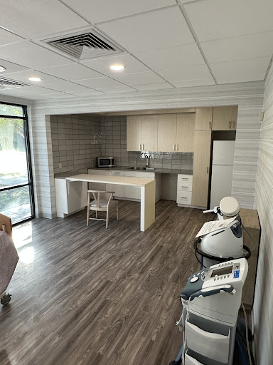A modern kitchen featuring sleek cabinetry and wood flooring.