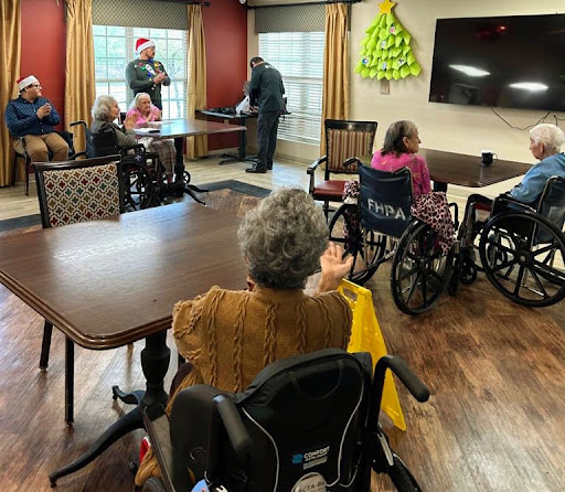 Residents of a care facility enjoying a social activity together.