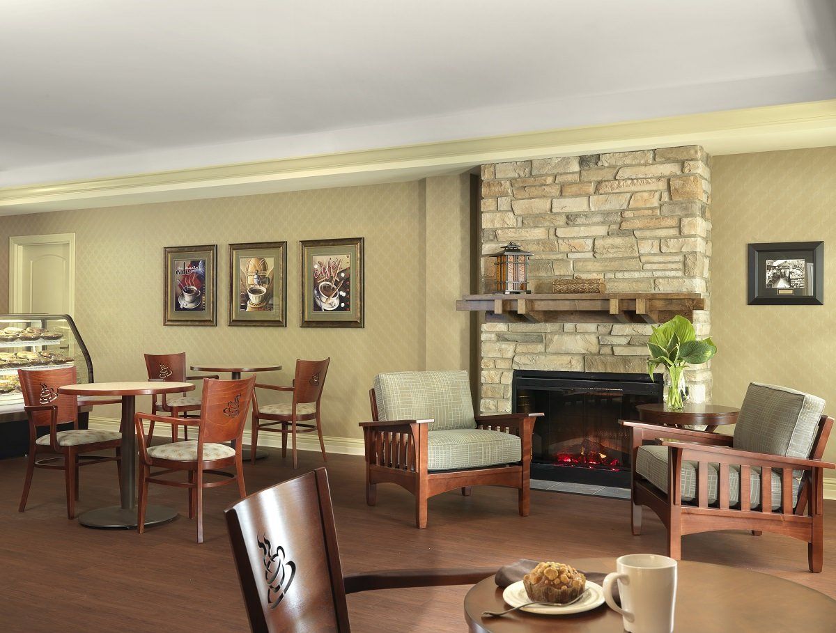 A cozy lounge area featuring comfortable seating and a stone fireplace.