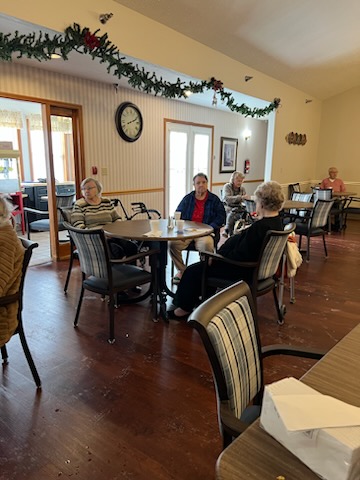 Seniors enjoying a social gathering in a cozy dining area.