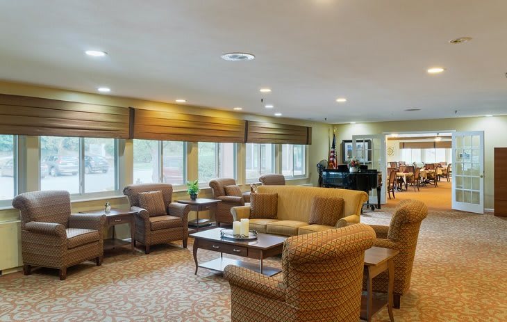 Spacious lounge area with comfortable seating and large windows.