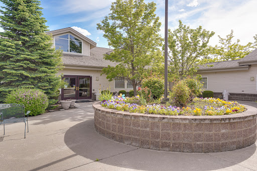 A beautifully landscaped garden surrounding a modern building.