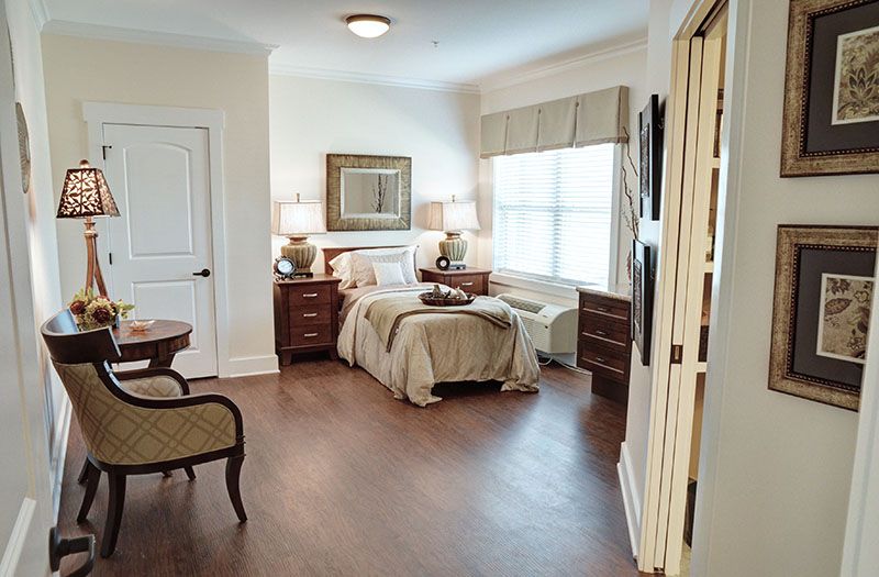 A cozy bedroom with elegant furniture and natural lighting.