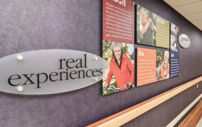 A wall display featuring photographs and text under the title 'real experiences'.