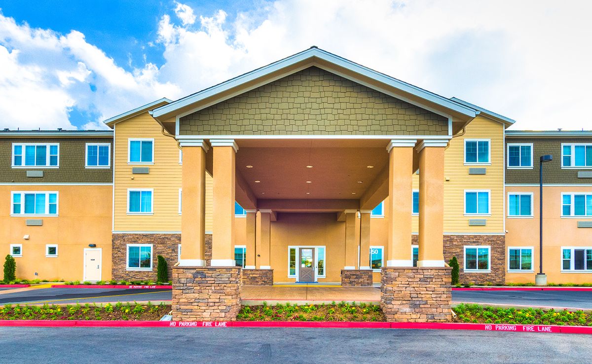 Exterior view of a hotel building with a prominent entrance and columns.