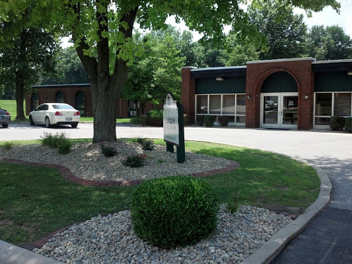 A well-maintained commercial building with landscaped surroundings.