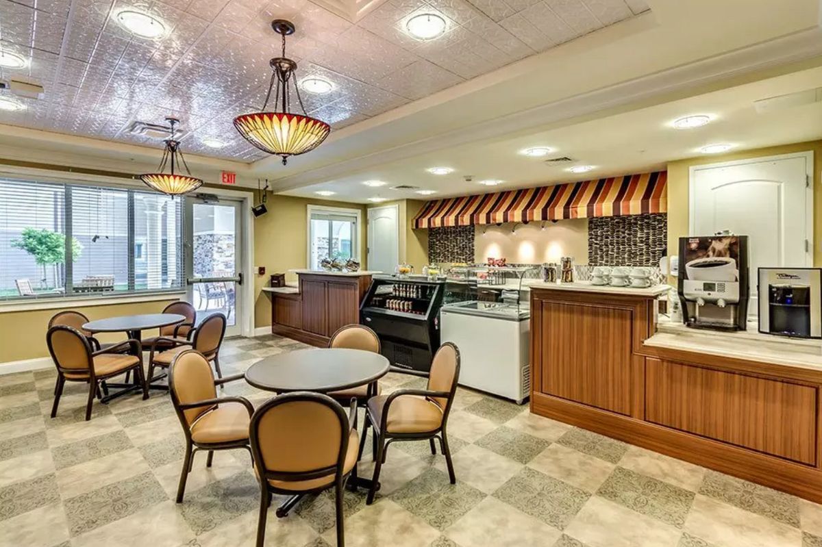 A cozy cafe interior with a counter and seating area.