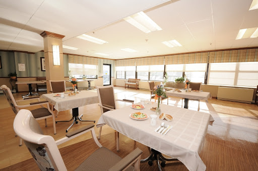 A bright and modern dining area with neatly set tables, creating a welcoming atmosphere.