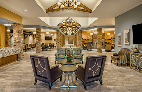 A stylish and welcoming lobby featuring modern furnishings and elegant chandeliers.