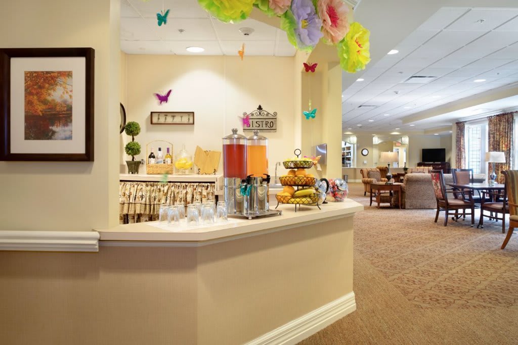 A brightly decorated refreshment bar featuring a variety of drinks and snacks.
