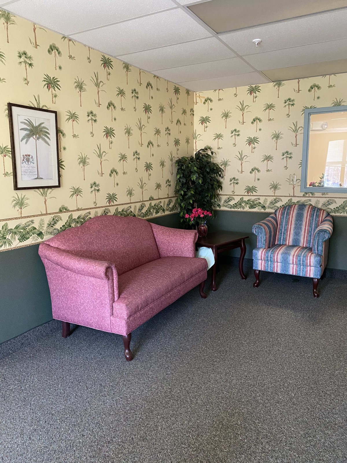 Cozy living room with a pink sofa and striped armchair.