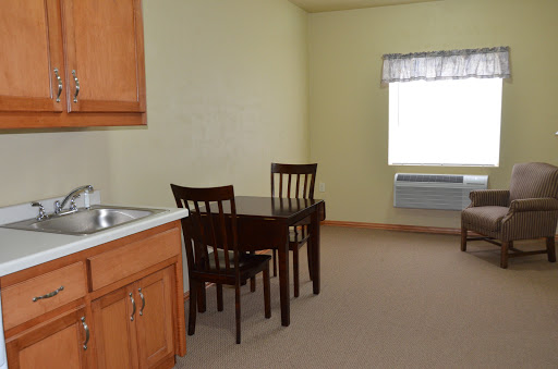 A simple and cozy kitchen and dining area featuring a table and chairs, with light-colored walls for a bright atmosphere.