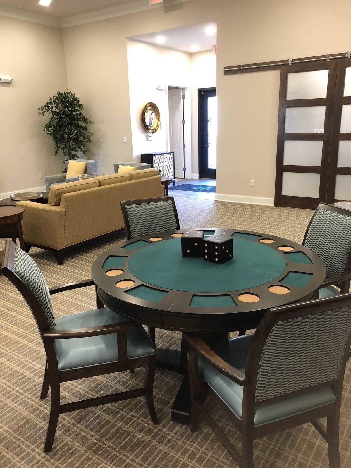 A cozy lounge area featuring a card table and chairs.