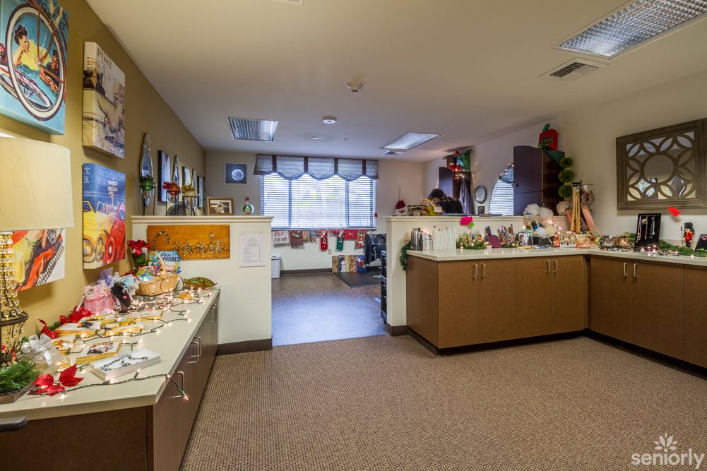A decorated office space with various gifts and festive decorations.