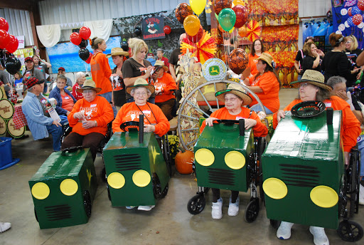 Children in creative costumes participate in a lively fall festival parade.