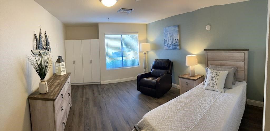 A modern and cozy bedroom interior with a reclining chair.