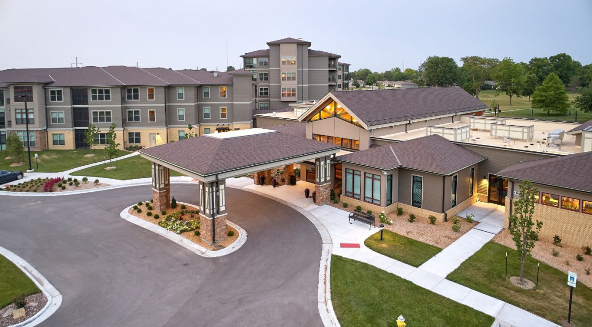 A modern residential complex with a welcoming entrance and driveway.