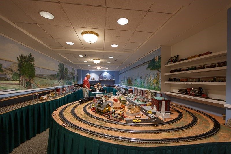 A detailed model train setup on display in an indoor setting.