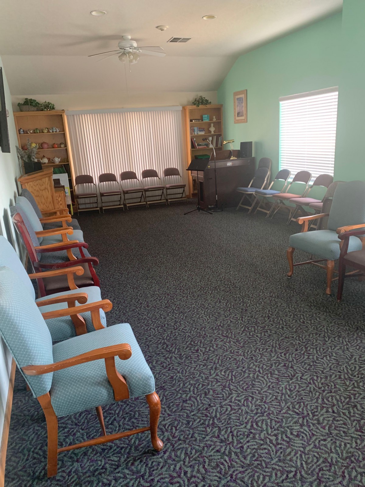 A spacious waiting room with multiple chairs arranged around the walls, offering a comfortable seating area.
