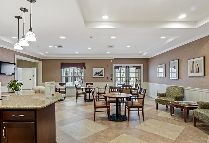 A cozy dining area with tables and chairs, well-lit and inviting.