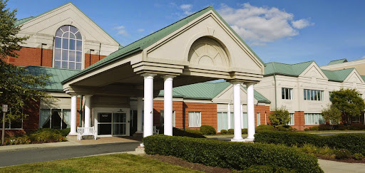 The entrance of a modern building featuring classic architectural elements.