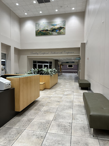 A spacious and modern lobby featuring a reception desk and seating areas.
