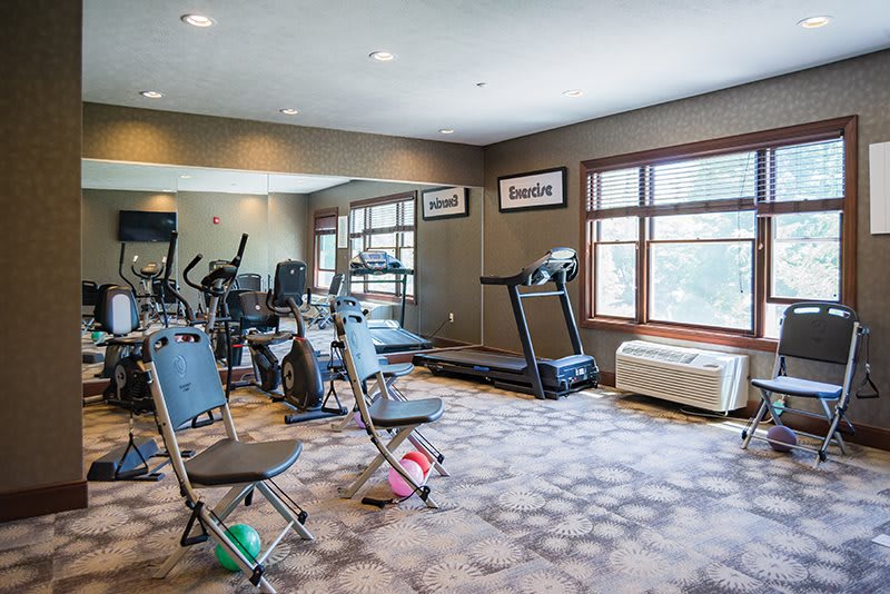 A well-equipped gym with various fitness machines and weights.