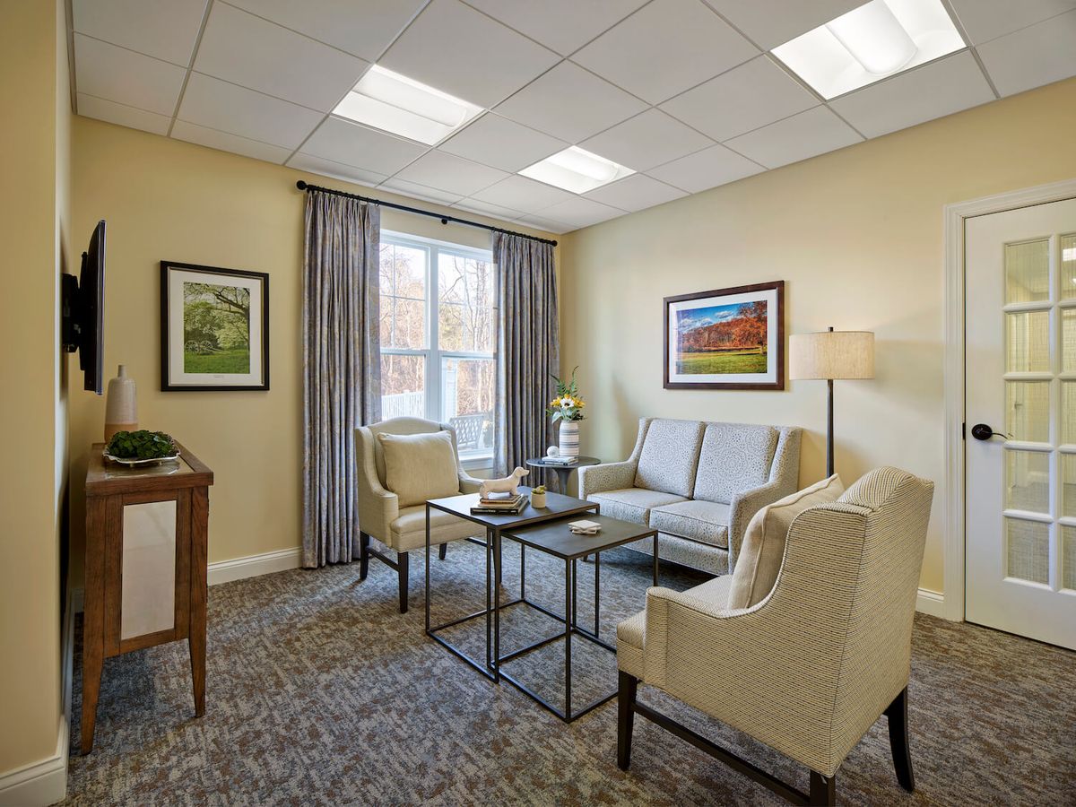 A cozy living room with comfortable seating and tasteful artwork.