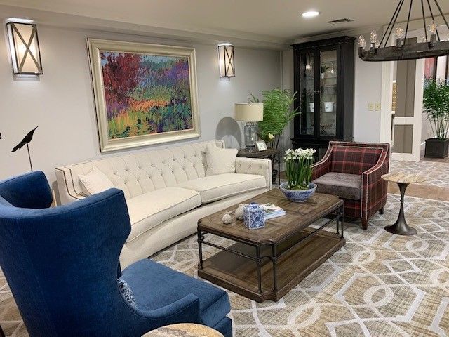 A cozy living room with elegant furniture and colorful artwork.