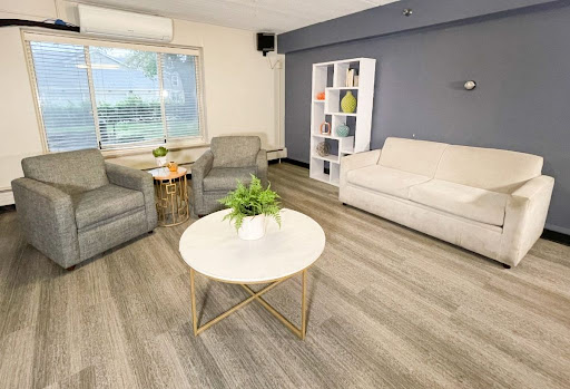 A modern and cozy living room featuring comfortable seating and a bright atmosphere.