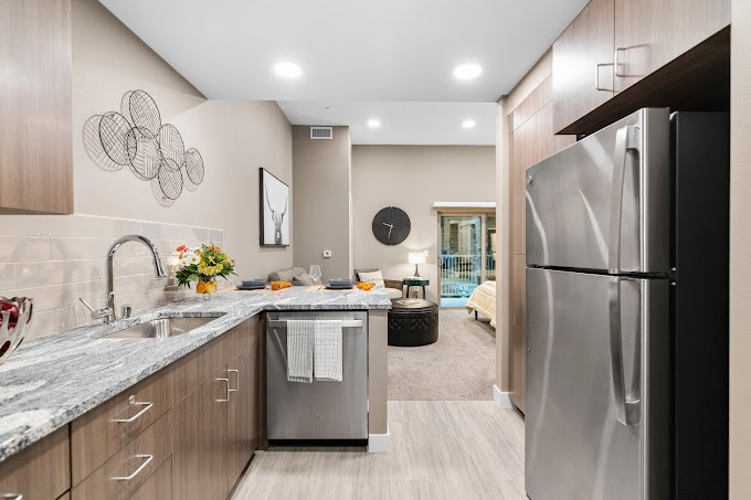 A modern kitchen with stainless steel appliances and stylish decor.