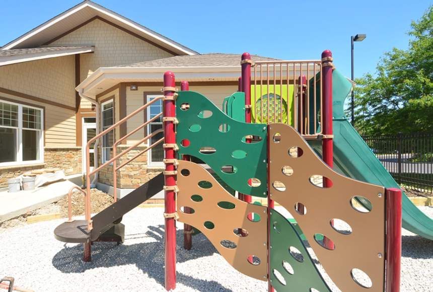 A colorful playground with slides and climbing equipment on a sunny day.