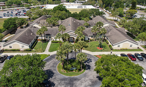 Aerial view of a residential building surrounded by trees.