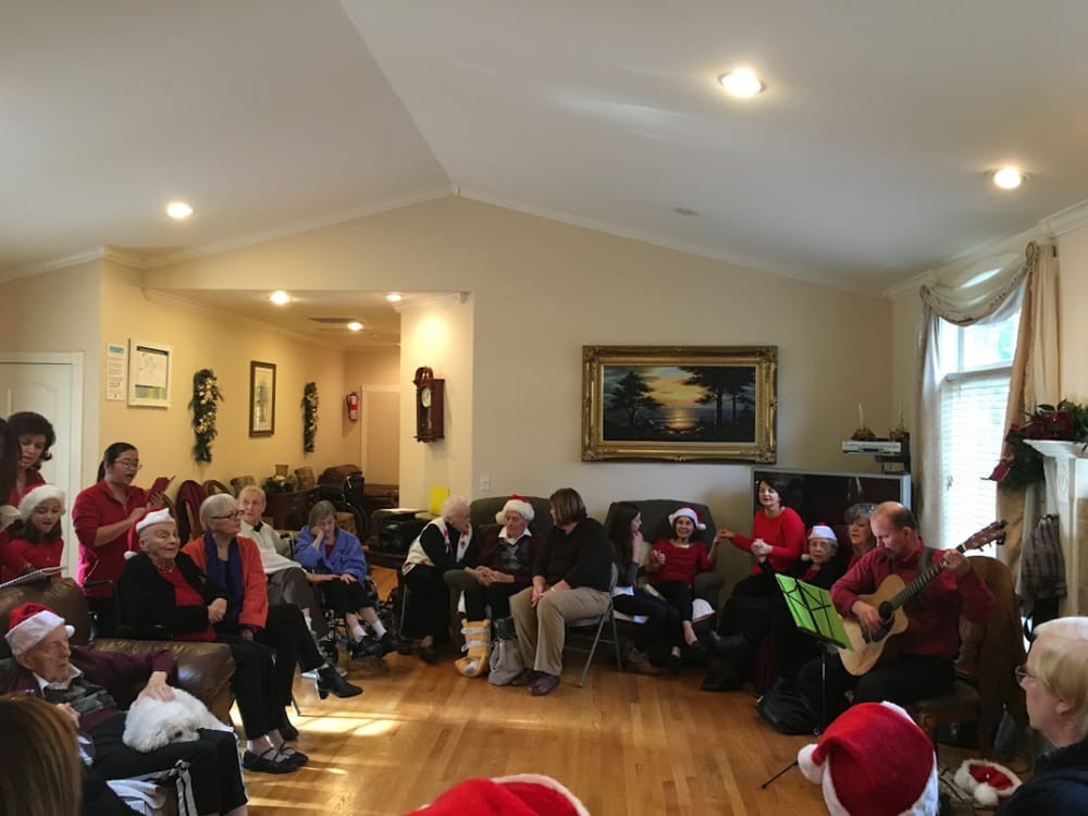 A festive group gathering in a living room celebrating Christmas.
