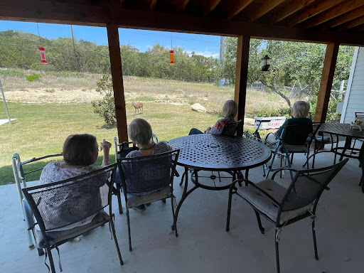 A group of seniors enjoying a peaceful view from their porch.