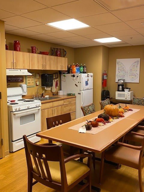 A cozy kitchen and dining area with autumn-themed decorations on the table.