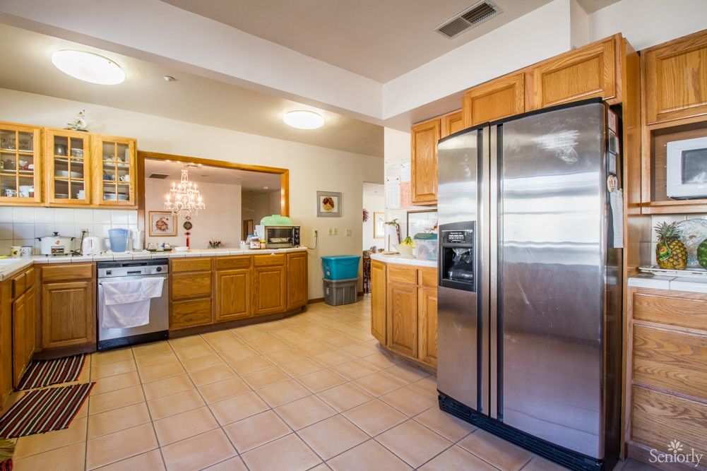 Spacious kitchen with wooden cabinets and modern appliances.