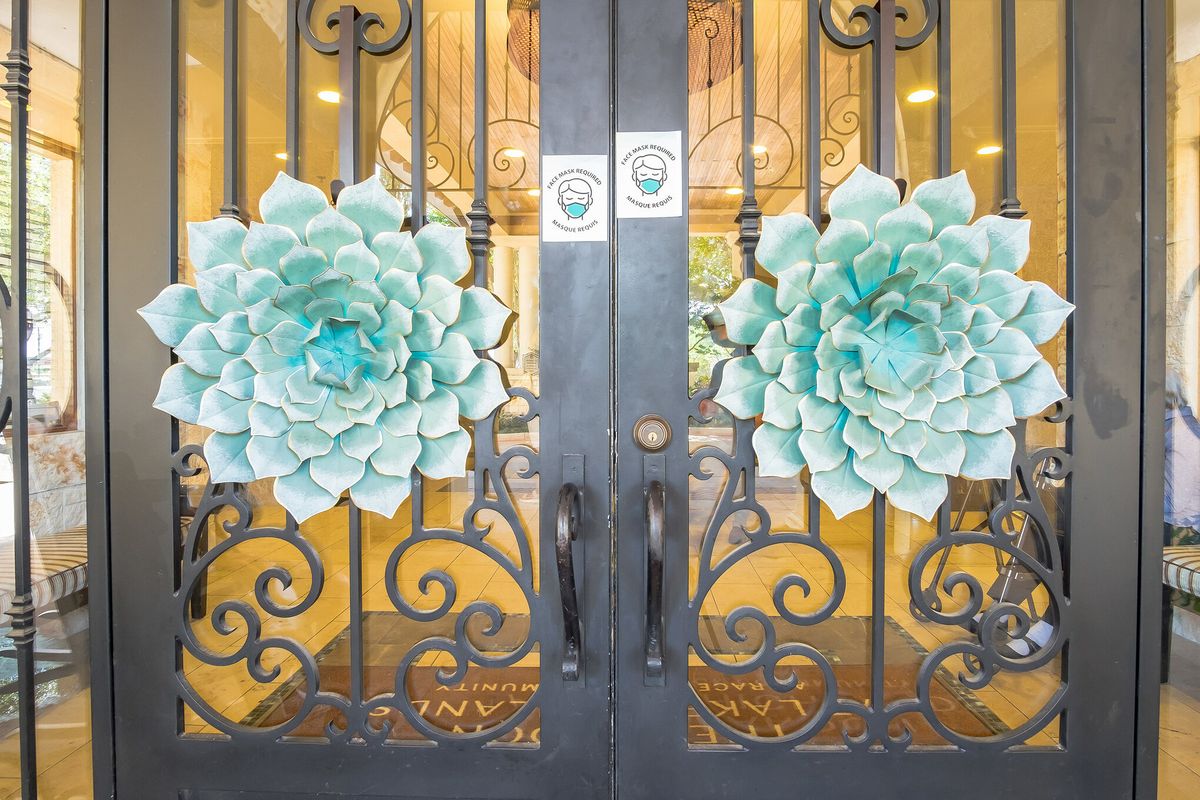 Decorative glass doors with large teal floral elements.