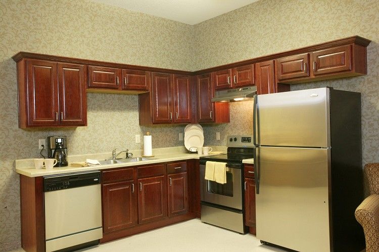 A modern kitchen with stainless steel appliances and wooden cabinets.